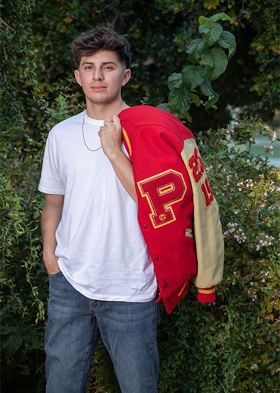 Evoto senior portrait young man outdoors letterjacket